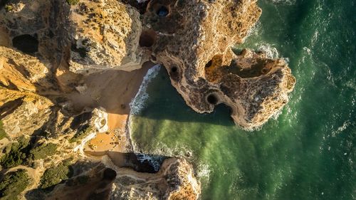 Aerial view of rock formations at beach