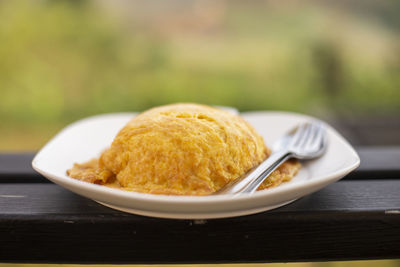 Close-up of fried egg with spoon and fork