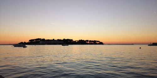 Scenic view of sea against orange sky