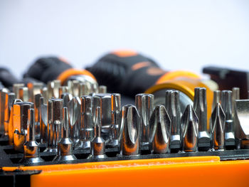 Close-up of drill bits against white background