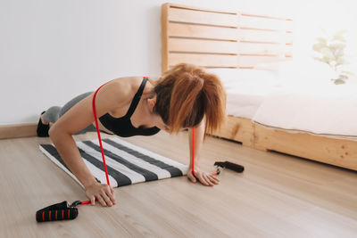 Woman sitting on floor at home