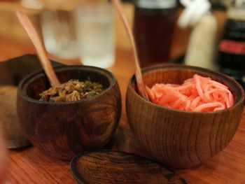 Close-up of food in wooden bowl containers on table