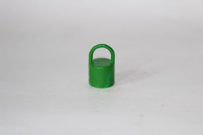 Close-up of green object over white background
