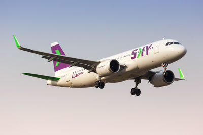 Low angle view of airplane against clear sky