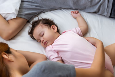 High angle view of baby sleeping on bed at home