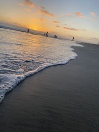 Scenic view of beach against sky during sunset