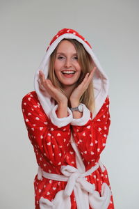 Portrait of a smiling young woman against white background