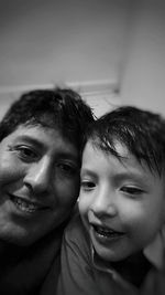 Close-up portrait of father with son at home