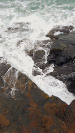 Close-up of water on beach against sky