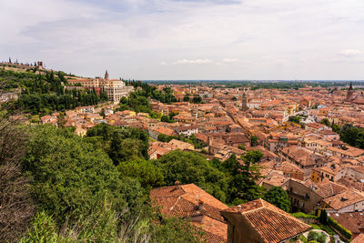 High angle view of townscape by sea against sky