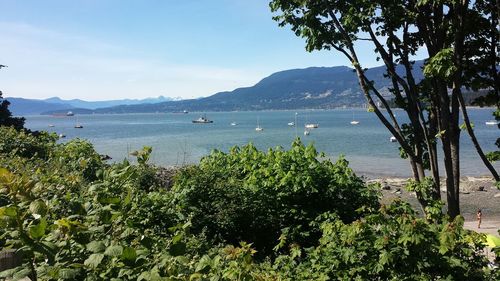 Scenic view of sea and mountains against sky