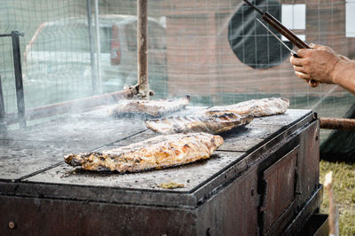 Man preparing meat on barbecue grill