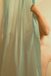 Close-up of hand on bed