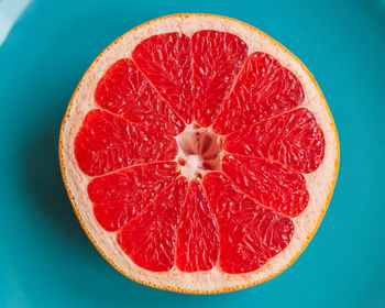 Close-up of fruits against blue background