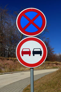 Road sign against clear blue sky