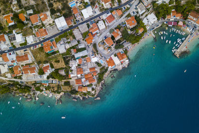 Aerial view of houses in town by sea
