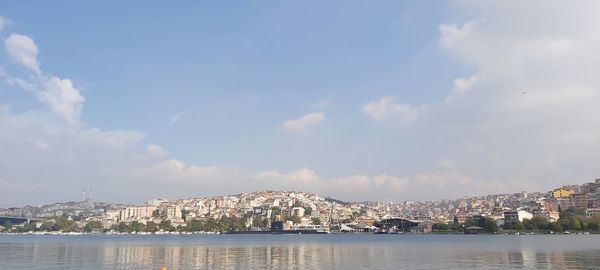 Panoramic view of buildings and sea against sky
