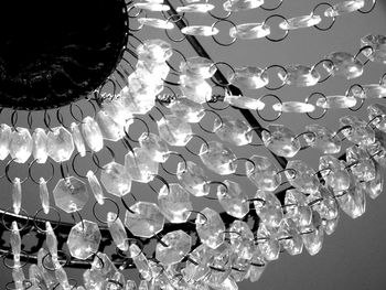 Low angle view of illuminated lighting equipment hanging on ceiling