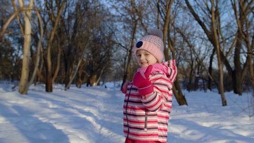 Girl wearing mask on field during winter