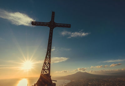 Low angle view of cross against sky during sunset