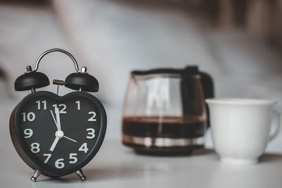 Close-up of clock on table