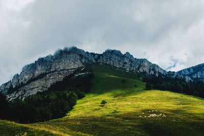 Scenic view of mountains against cloudy sky