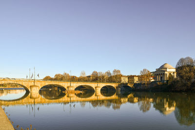 Bridge over river against clear sky