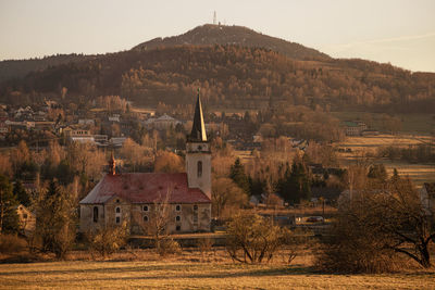 Houses on field against sky