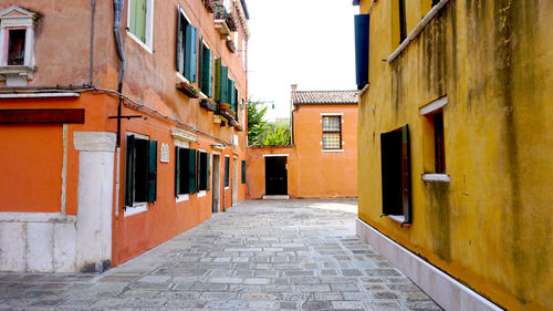 Alleyway with ancient building yellow and orange in venice, italy, europe
