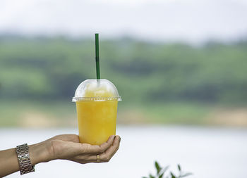 Close-up of hand holding drink