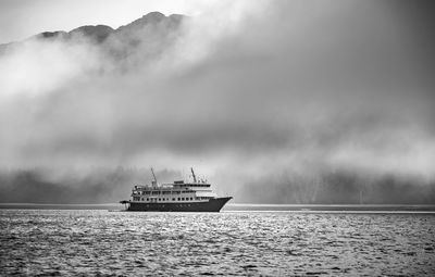 Ship sailing on sea against sky