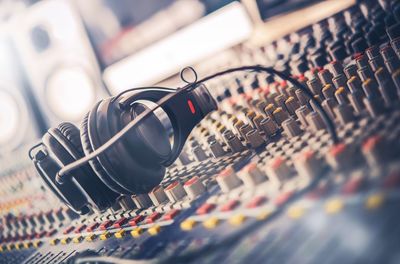 Close-up of headphones on sound mixer