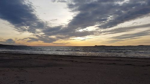 Scenic view of beach against sky during sunset