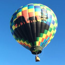 Low angle view of hot air balloon against blue sky