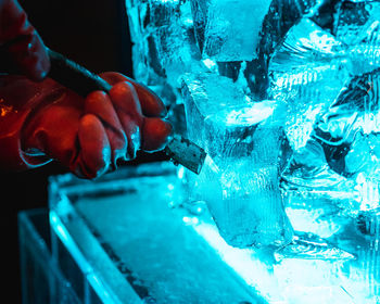 Close-up of hand carving ice