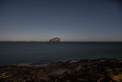 Scenic view of sea against clear sky at night