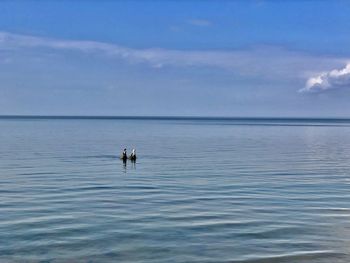View of two people fishing in sea