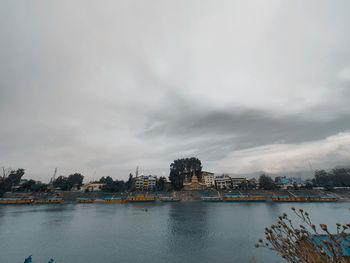 Buildings in city against cloudy sky