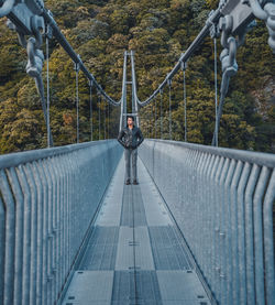 Man standing on bridge