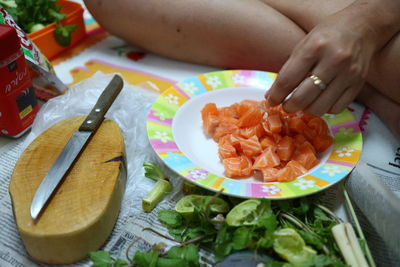 Close-up of person preparing food on table