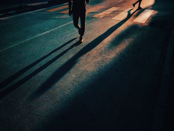 Low section of people walking on road