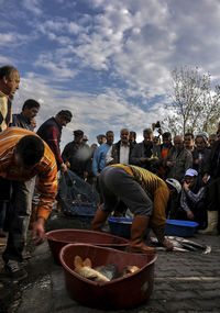 Group of people in traditional clothing against sky