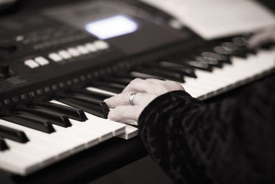 Close-up of man playing piano