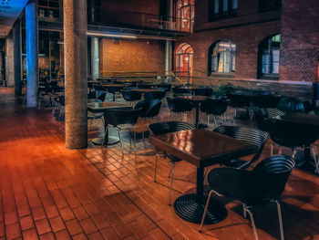 Empty chairs and tables in building