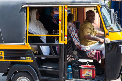 Rear view of people sitting in car