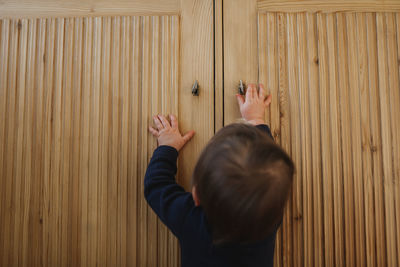 Full length portrait of boy standing on wood