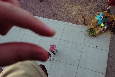 Low section of woman standing on footpath