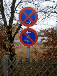 Close-up of road sign against sky