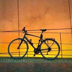 Bicycle parked at sunset