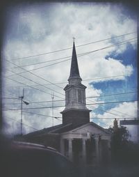 Low angle view of church against cloudy sky